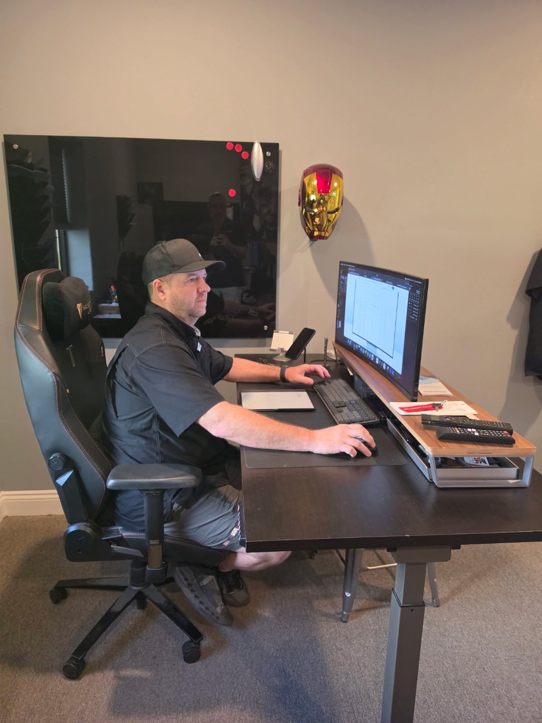 Clint Holt, CEO of SmartIT LLC, working at a standing desk with dual monitors